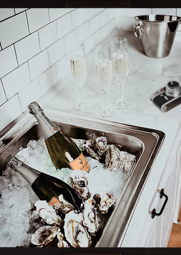 Champagne on ice in a sink